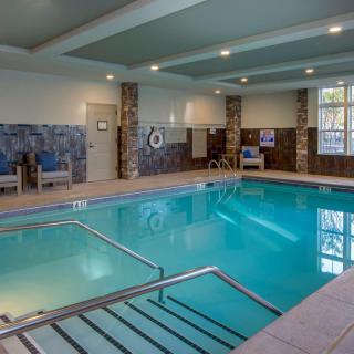 A tranquil indoor swimming pool area in a hotel setting.