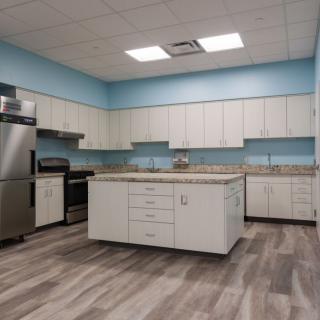 A modern kitchen with an island and stainless steel appliances.