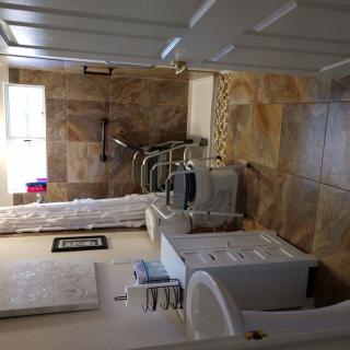 A well-equipped bathroom with a wheelchair accessible shower and sink area.