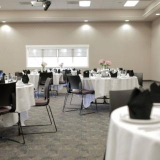 A formal banquet hall with tables set for an event.
