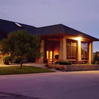 A residential house illuminated at night with lights on.