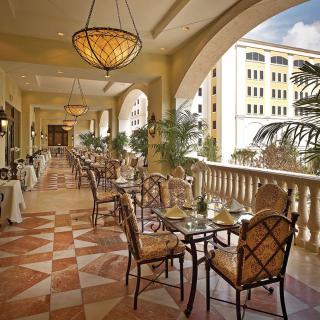 Elegant restaurant balcony with outdoor seating.