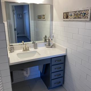 A modern bathroom with a sleek vanity and mirror.