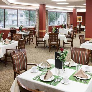 Elegant dining room with neatly set tables and comfortable chairs.