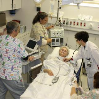 A team of medical professionals attending to a patient in a hospital setting.