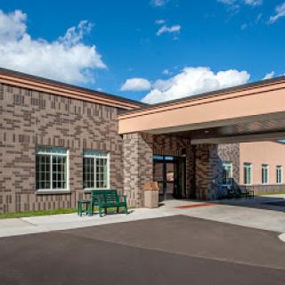 A welcoming entrance to a hospital facility on a sunny day.