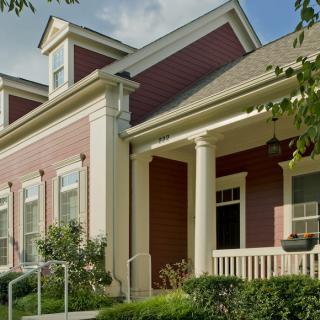 A charming suburban house with a spacious porch and classic architectural details.