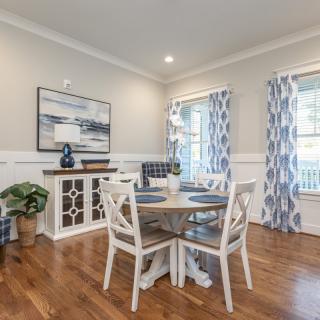 A cozy dining room with a round table and elegant decor.