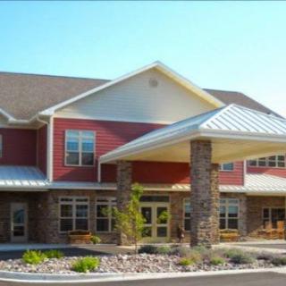 A modern residential building with a pitched roof and stone accents.