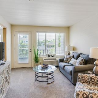 A cozy and modern living room with a comfortable sofa and large windows.