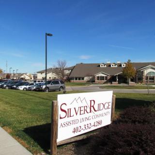 Silver Ridge Assisted Living facility with a parking lot and clear sky.