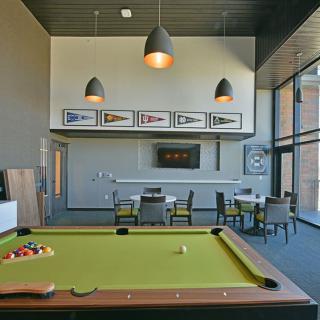 A modern game room featuring a billiards table and stylish decor.
