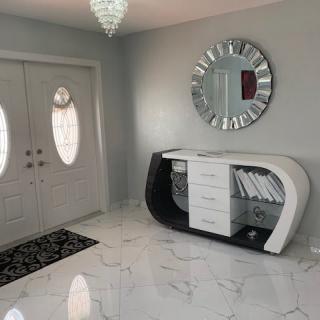 Modern entryway with a unique console table and mirror.