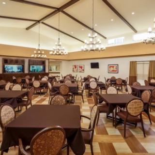 Spacious dining area with elegant tables and chandeliers.