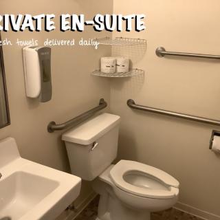 An accessible private en-suite bathroom with grab bars and essential amenities.