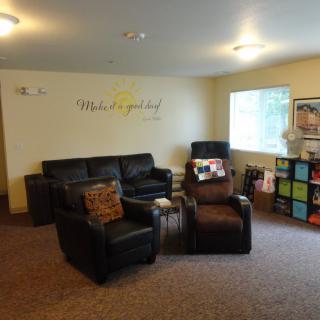 A cozy living room with comfortable seating and decorative elements.