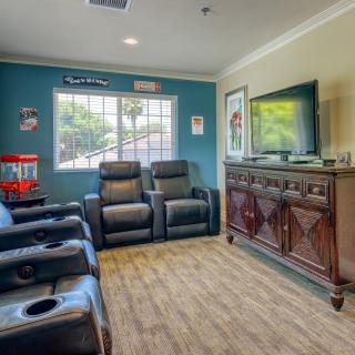 A cozy home theater setup with recliners and a large-screen TV.