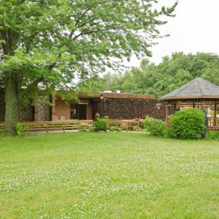A spacious yard with a house, gazebo, and lush greenery.