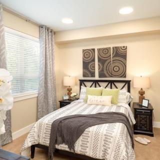 A modern and cozy bedroom decorated with stylish artwork and soft lighting.