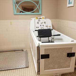 An accessible bathtub with a seat, designed for hydrotherapy use.
