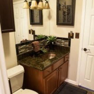 A cozy bathroom with a modern sink and elegant lighting.