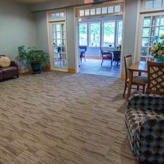 A cozy living room with comfortable seating and a view of the dining area.