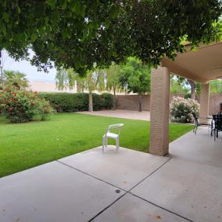 A serene outdoor space featuring a well-maintained garden and patio area.