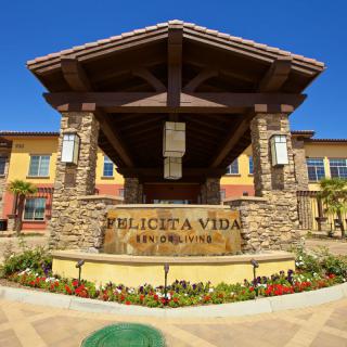 Entrance to Felicita Vida, featuring stonework and modern architectural elements.