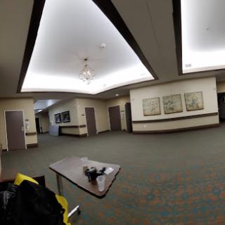 A spacious lobby area featuring modern lighting and artwork on the walls.