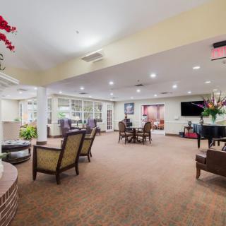 A spacious and well-lit lounge with comfortable seating and elegant decor.