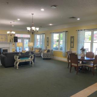 A spacious living room with sofas, tables, and large windows providing ample natural light.