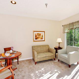 A cozy living room with a small dining area and natural light.