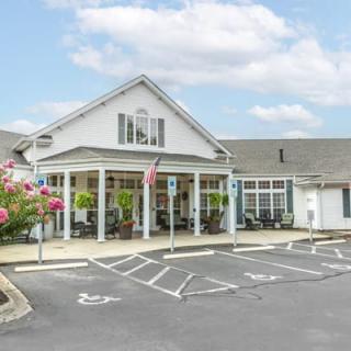 A quaint residential building with a parking lot and handicap spaces.