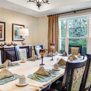 A beautifully set dining room table with elegant decor and warm lighting.