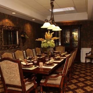 An elegantly decorated dining room set for a formal dinner.