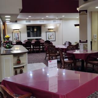 An empty dining area with neatly arranged tables and chairs.