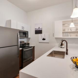 A modern kitchen with stainless steel appliances and a sleek countertop.
