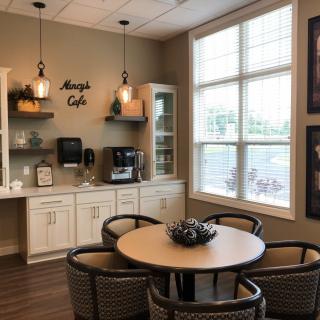 A cozy cafe interior with a seating area and coffee station.