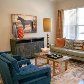 A cozy living room with stylish furniture and artwork.