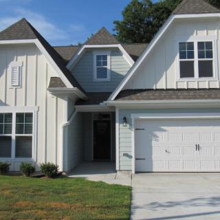 A modern residential house with a garage and front yard.