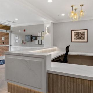 A modern reception area with a sleek desk and stylish lighting.