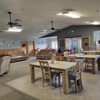 A spacious and cozy living area with a dining table, sofas, and comfortable decor.