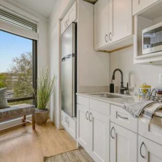 A modern, cozy kitchen with natural light and a window seat.