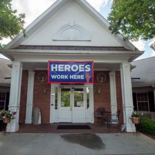A building entrance with a banner that reads 'Heroes Work Here'.