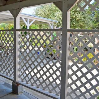 A lattice fence providing a decorative boundary for the patio area.