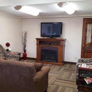 A cozy living room with a fireplace and TV.