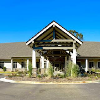 A modern residential facility with a welcoming front entrance and landscaped surroundings.