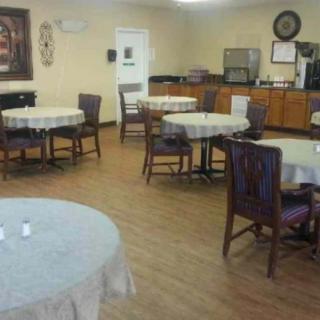 An empty dining area with tables and chairs arranged neatly.