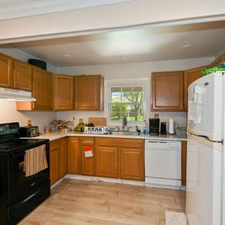 A cozy kitchen with wooden cabinets and modern appliances.