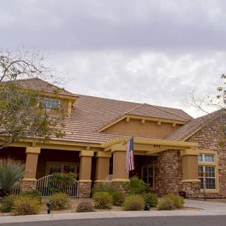 A suburban residential house with a stone facade and well-maintained landscaping.